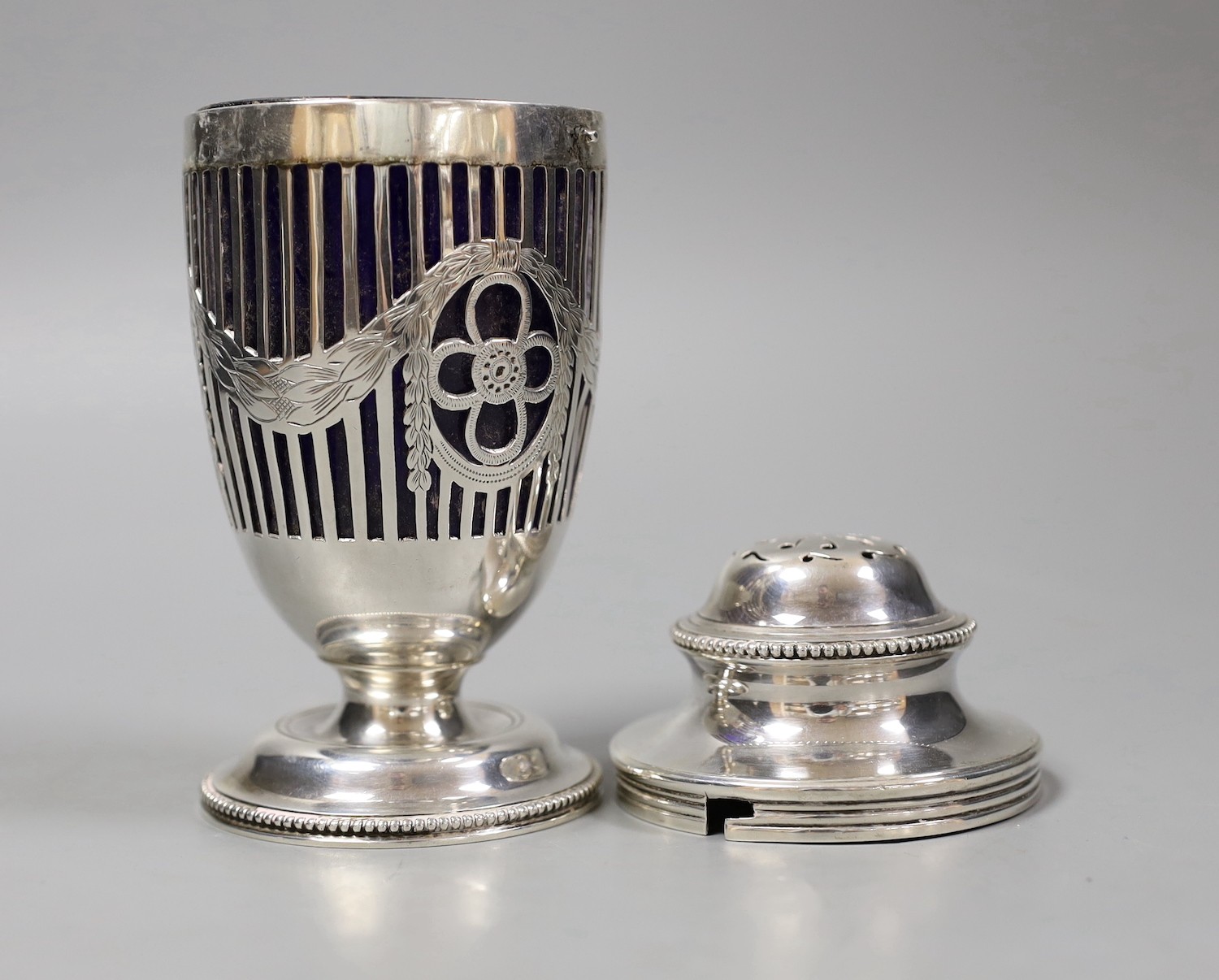 An Edwardian pieced silver vase shaped sugar caster, by Elkington & Co, London, 1909, with blue glass liner, height 14.9cm.